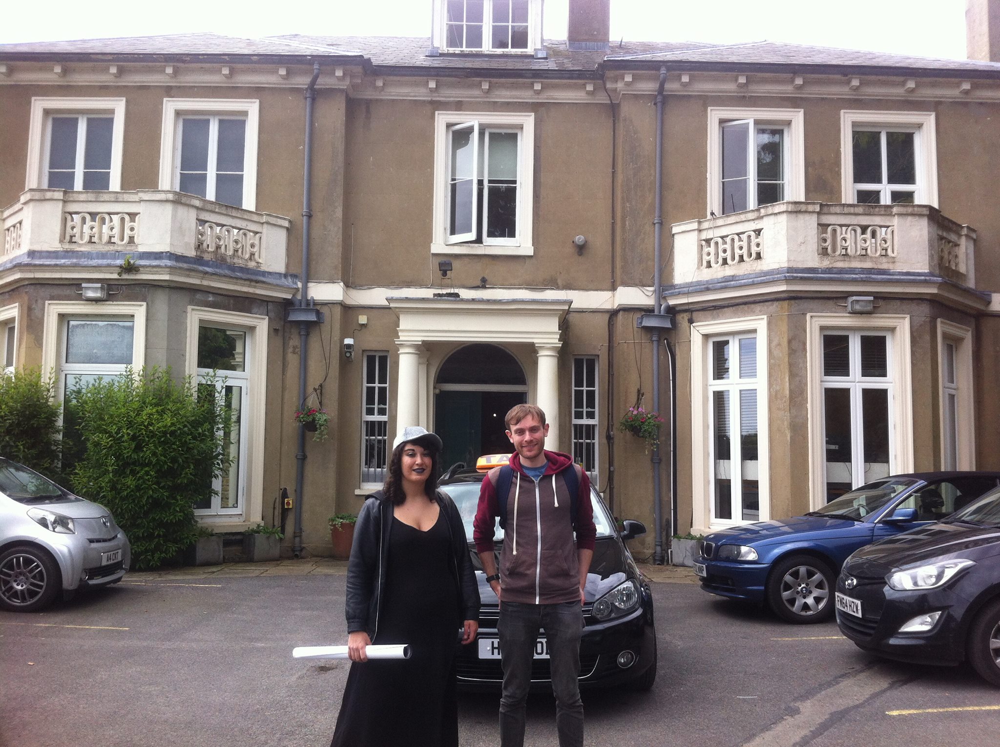 Marika and Luke standing outside an old stately building