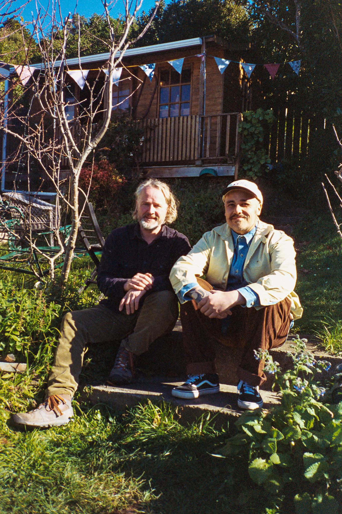 Al Fraser and Riki Gooch sitting in a sunny garden