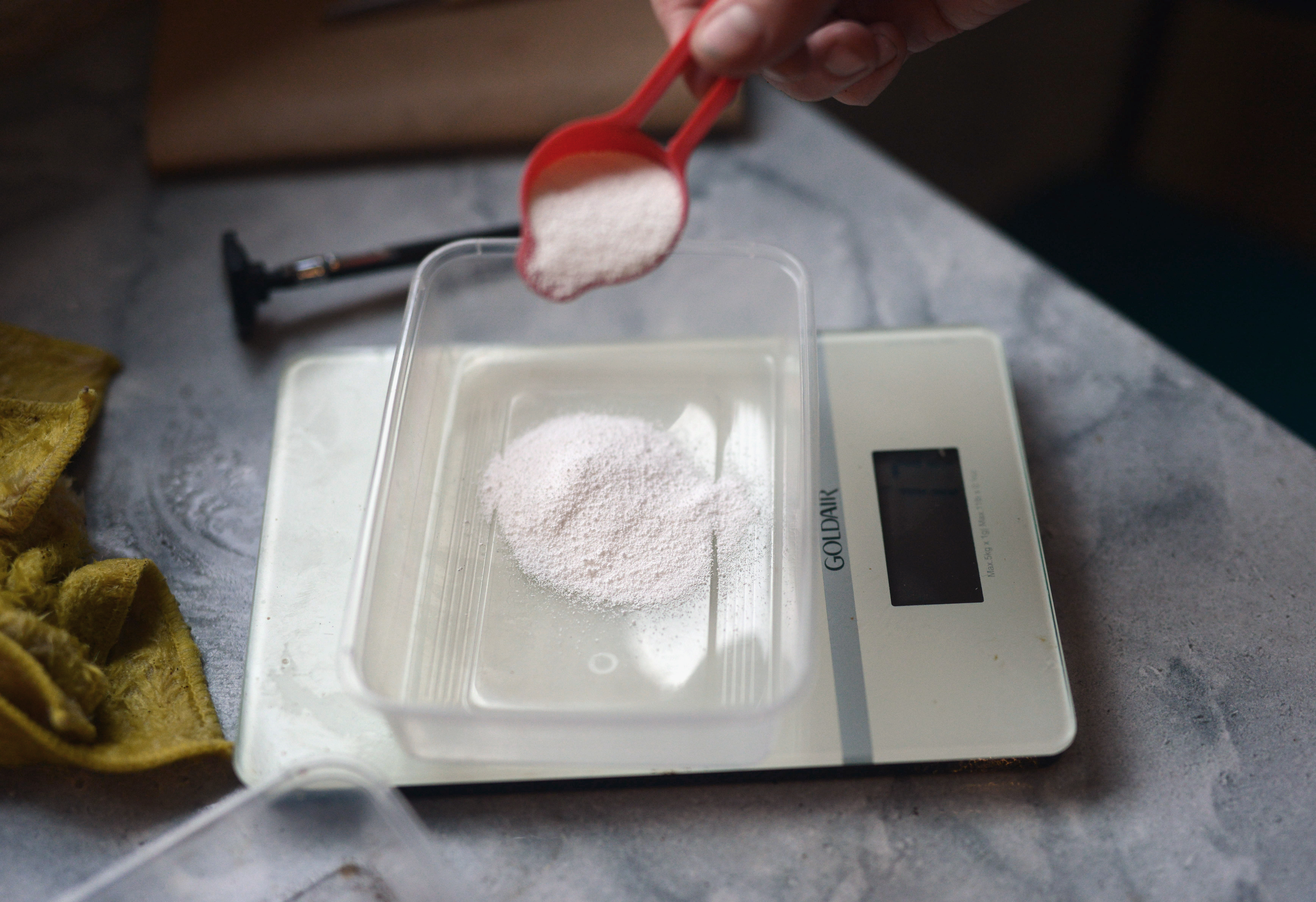 a container with white powder on a set of elctronic scales