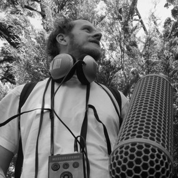 Reuben in a forest with recording equipment