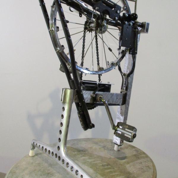 Neil Feather's 'Melocycle' invented instrument from 2016. The instrument combines a bicycle wheel with pedals and some kind of mechanism that appears to perhaps strum the spokes of the wheel. 