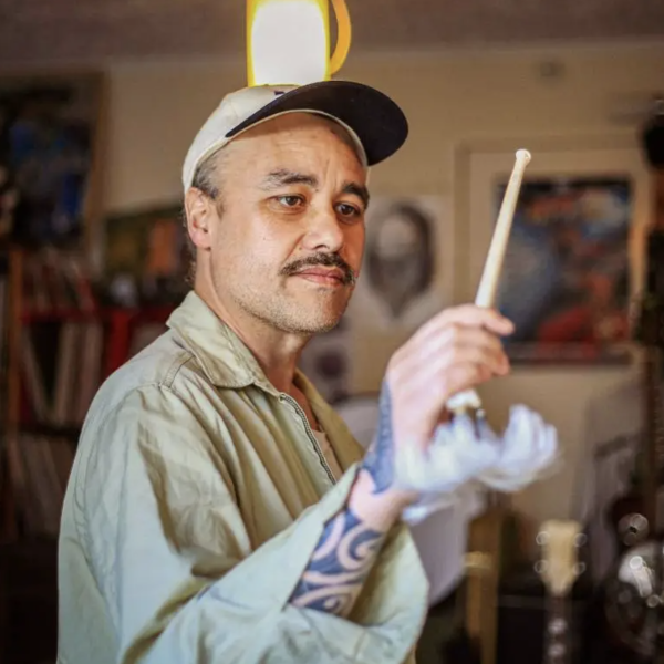 A photo of Riki Pirihi holding a drum stick 
