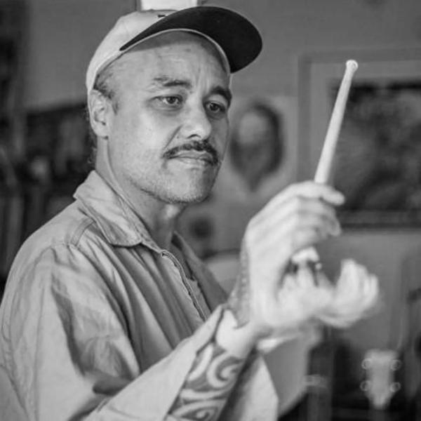 A black and white photo of Riki Pirihi mid-conducting