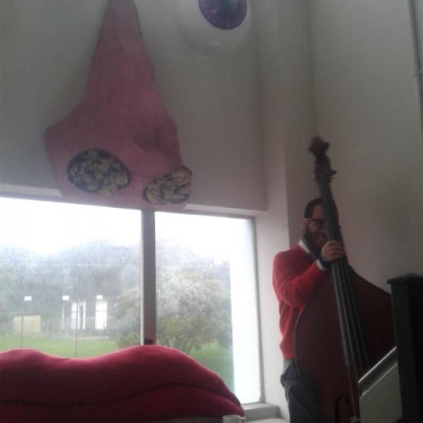 Isaac Smith taking pause, holding his double bass