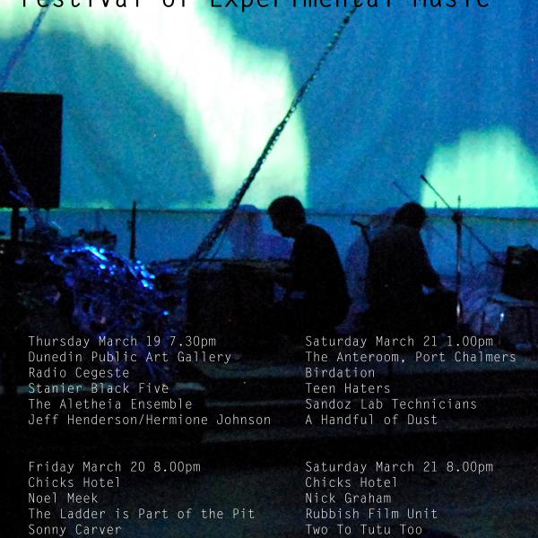 Lines of Flight poster for 2015. A photo of a performance. There are drums off to one side, and two people are on there knees perhoas creating feedback.