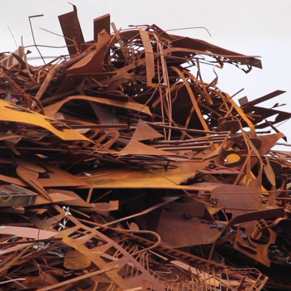 A large pile of rusted scrap metal sitting in a heap. It is spiky and uninviting.