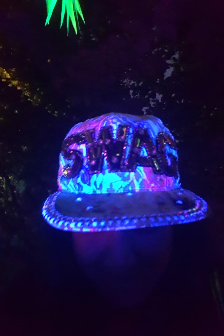 a glittery hat that has the word swag on the front