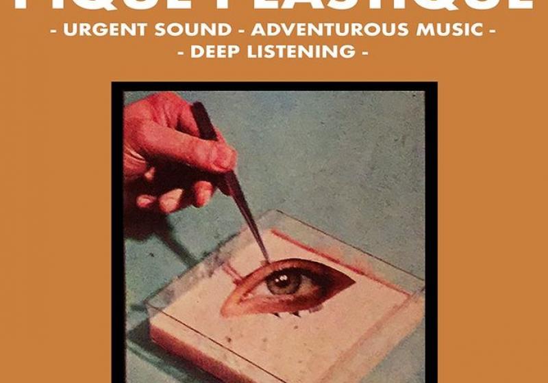 A hand with tweezers plucking an eye in a petri dish