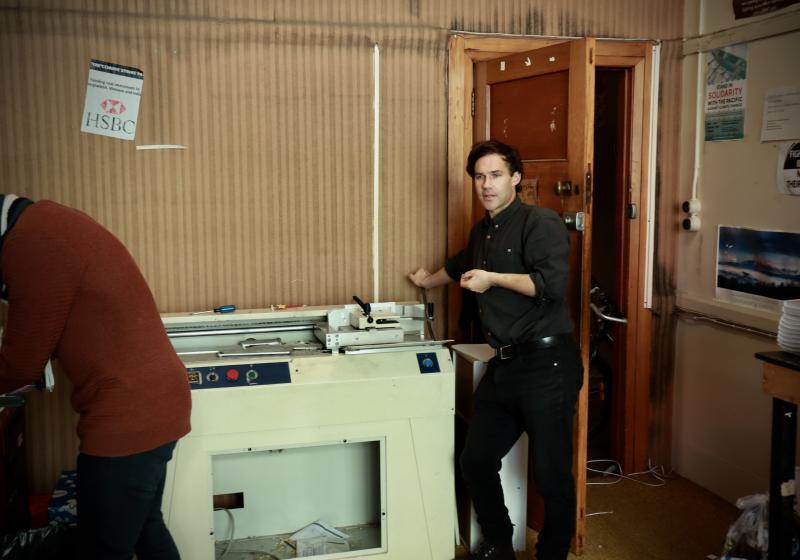 Photo of Murdoch Stephens leaning on a photocopier 
