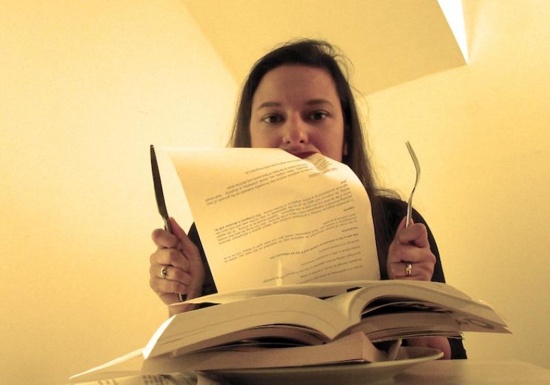 A person eating the pages of a script