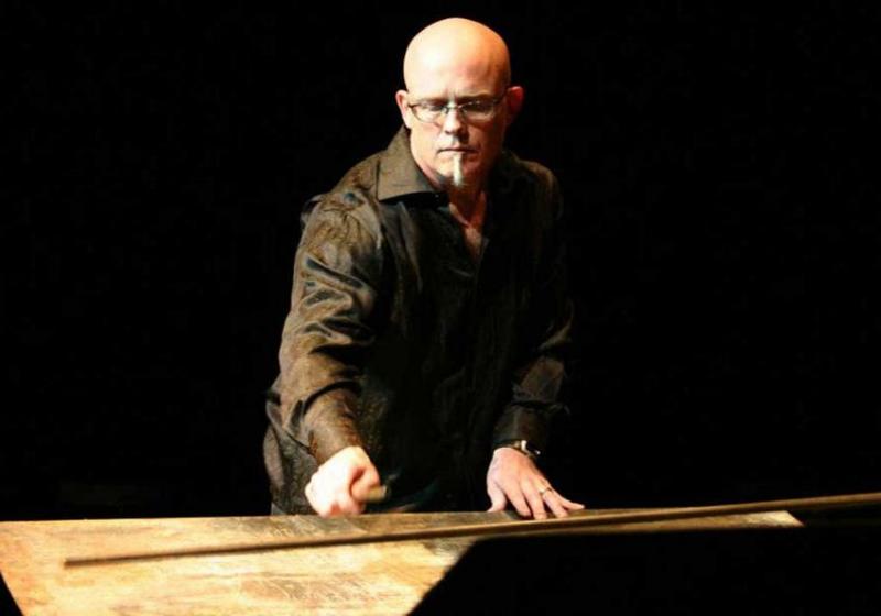 Neil Feather playing a piece of sheet metal