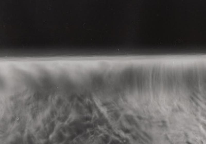 A grey and blurred image. It is difficult to tell if it is a vast landscape, or a small surface magnified