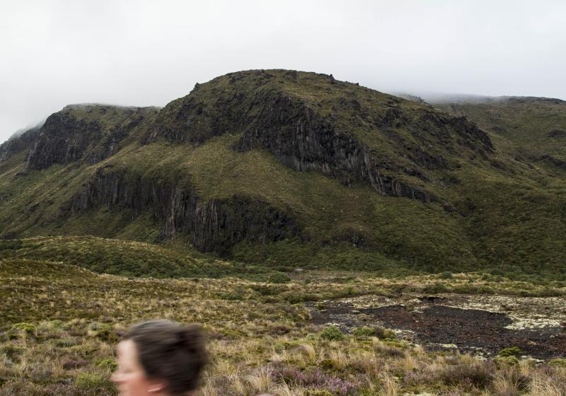 a heavy grey sky and some rocky scrubby hills. Antonia's head is just seen as a blur at the bottom.