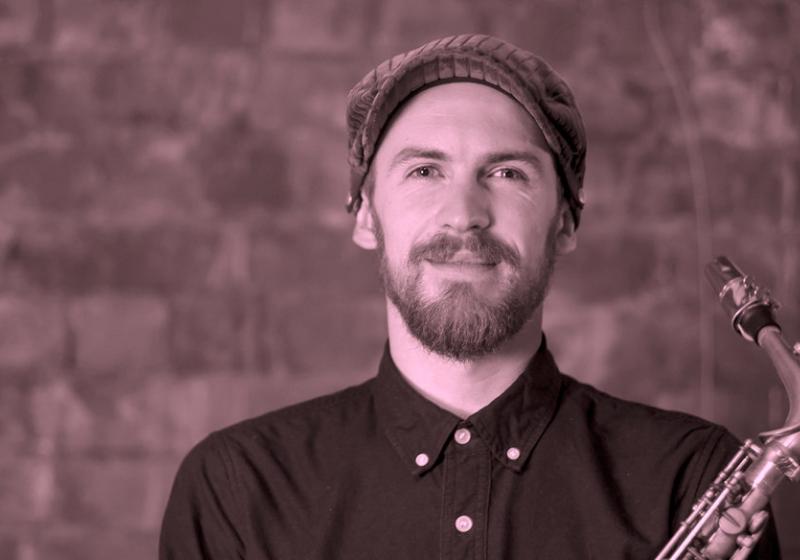 Jake Baxendale portrait with a saxophone