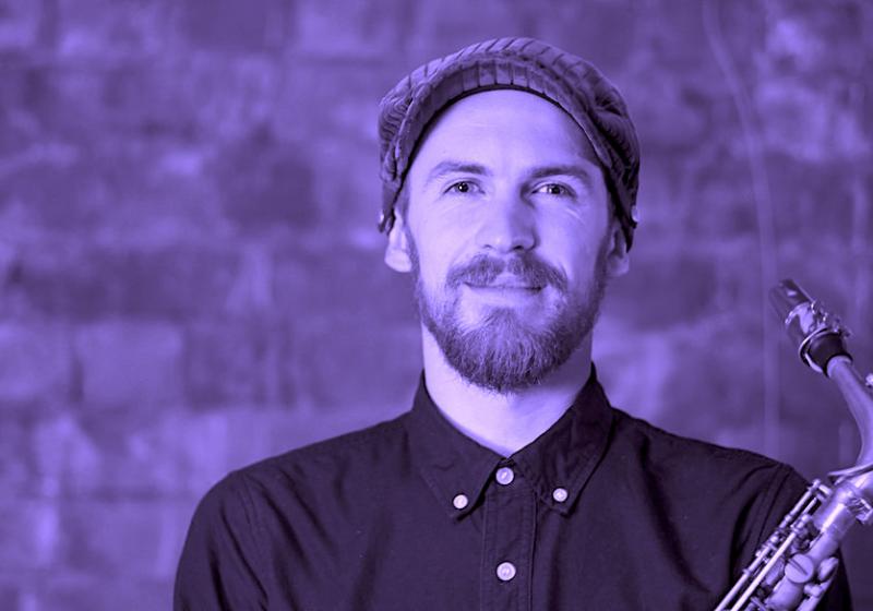 Jake Baxendale portrait with a saxophone