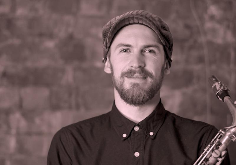 Jake Baxendale portrait with a saxophone