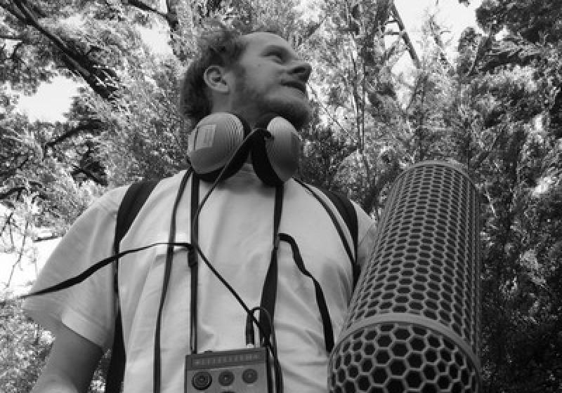 Reuben in a forest with recording equipment