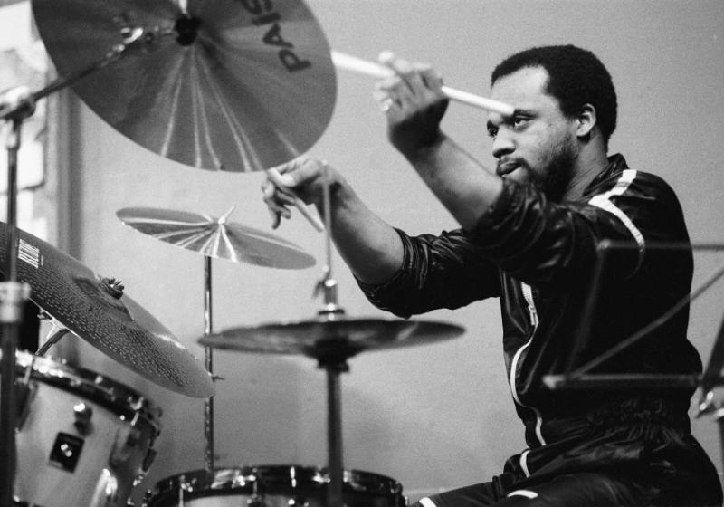 A black and white photo of Pheeroan playing drums