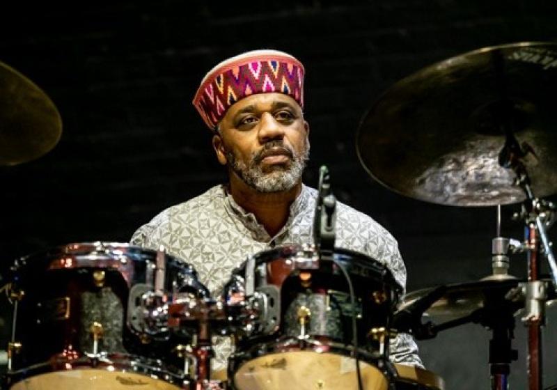 a colour photo of Pheeroan playing drums