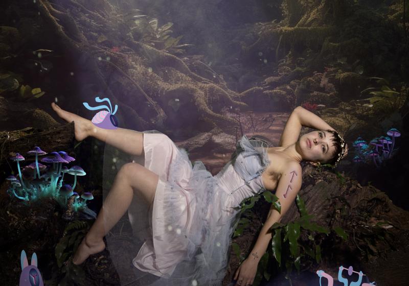 Calla lays in a science fiction forrest in a white dress