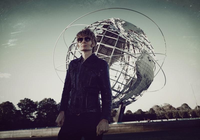 JG Thirwell standing in front of the spherical stainless steel 'Unisphere' representation of the Earth in Flushing Meadows–Corona Park in Queens, New York City. 