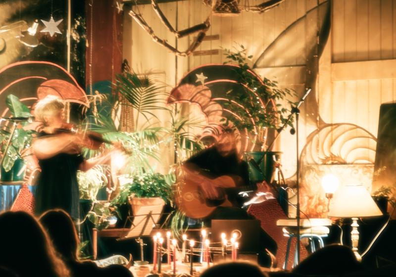 A blurred Serpent Dream jamming out in a warmly lit space