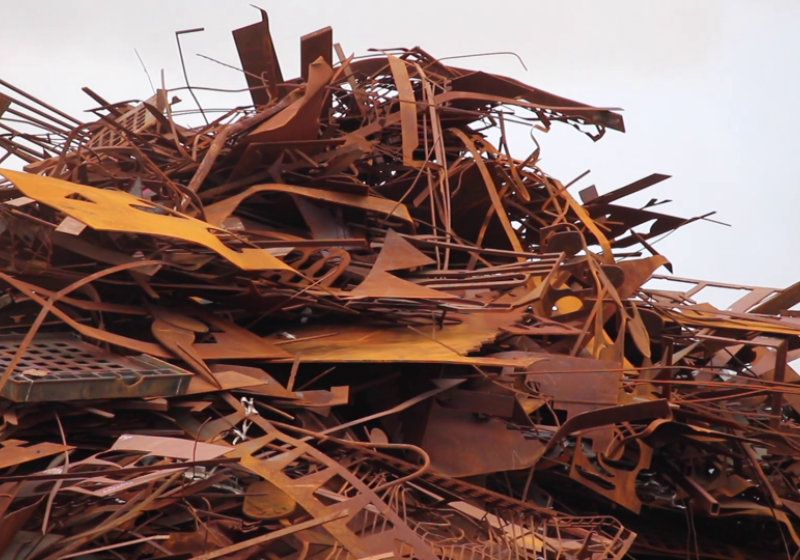 A pile of rusted scrap metal sitting in a heap.