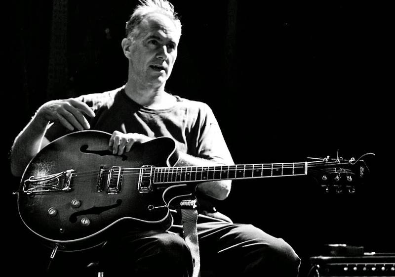 David Watson with a guitar, B&W photo