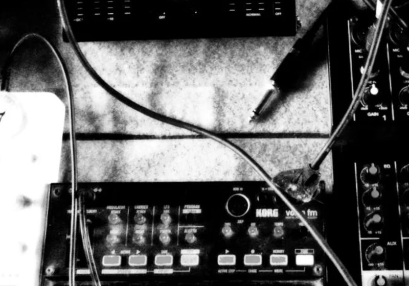 A rough black and white image of electronic music gear