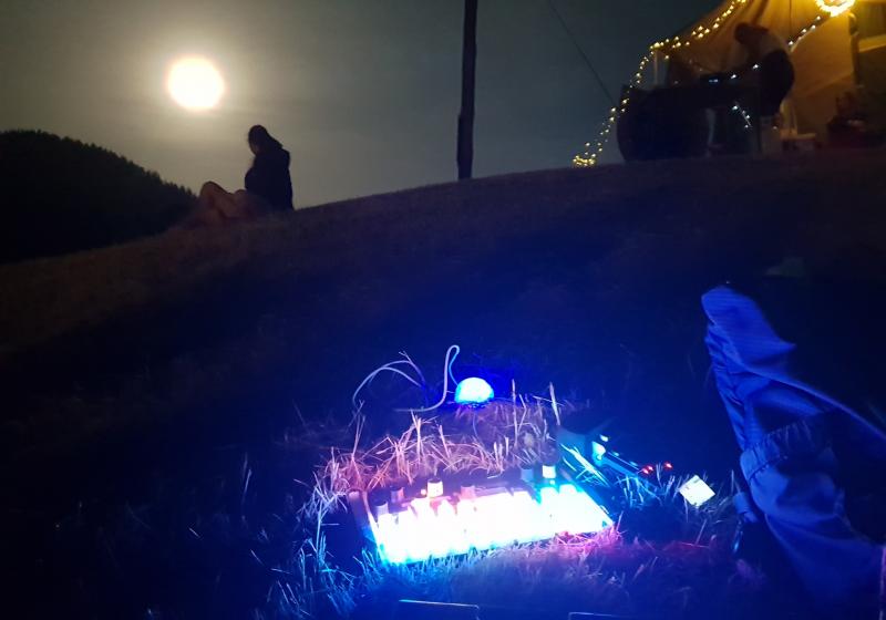 led lights of a sampler and a full moon in the sky.