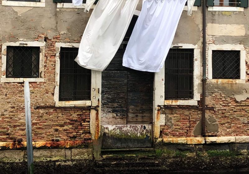 two sheets hanging to dry above the canals of Venice