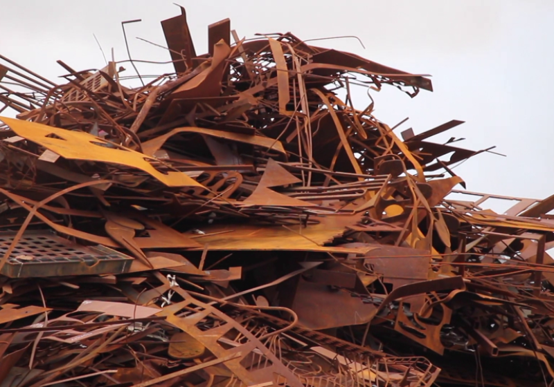 A large pile of rusted scrap metal sitting in a heap. It is spiky and uninviting.