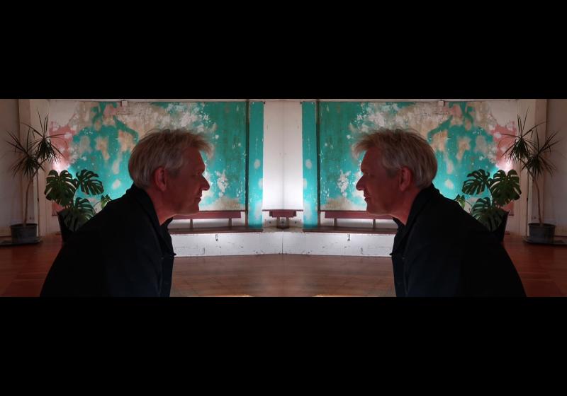 An image that is mirrored down the middle. Gabriel White appears to be staring intently at himself.