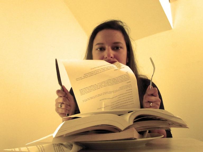 A person eating the pages of a script