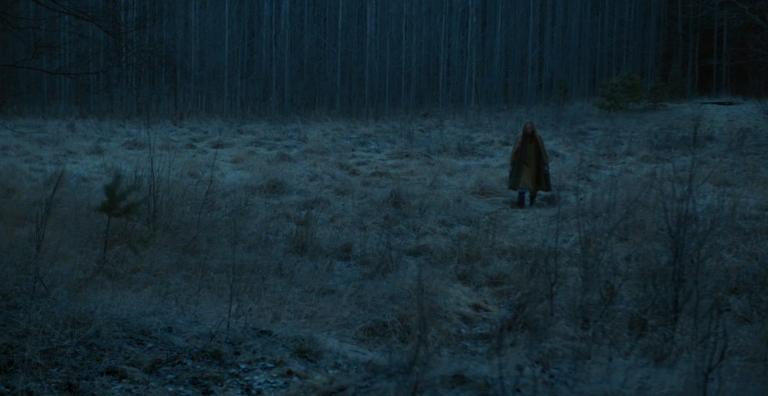 Anna Fält stands in a Nordic forrest in winter