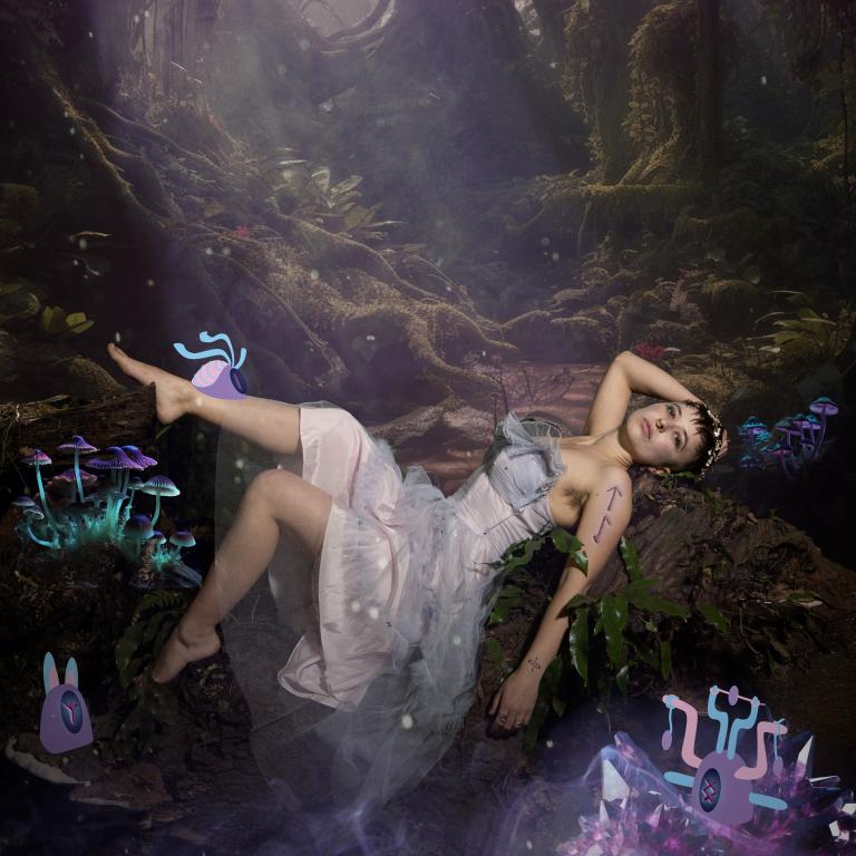 Calla lays in a science fiction forrest in a white dress