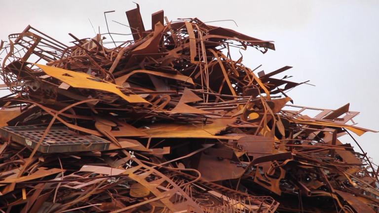 A pile of rusted scrap metal sitting in a heap.