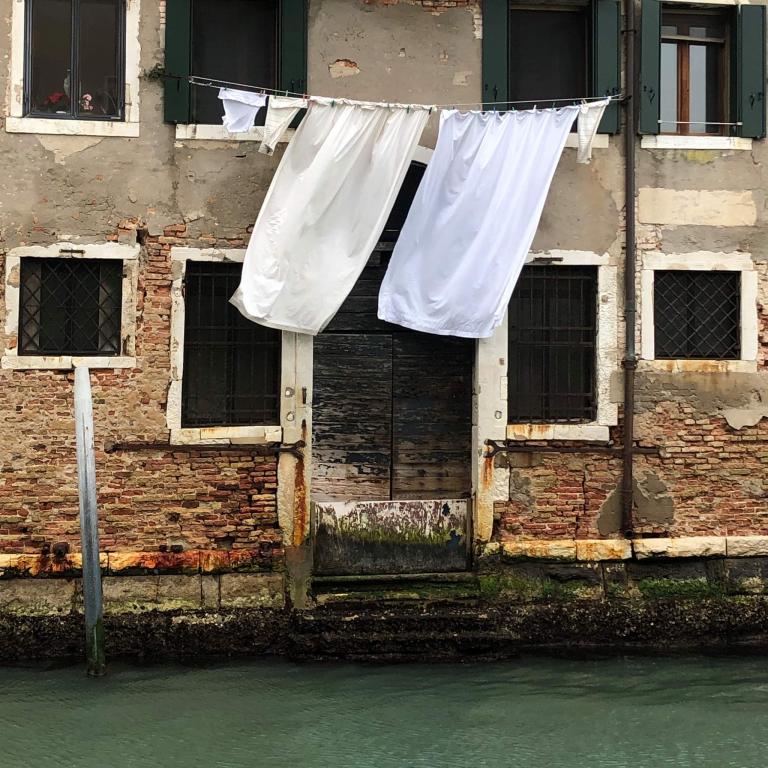 two sheets hanging to dry above the canals of Venice