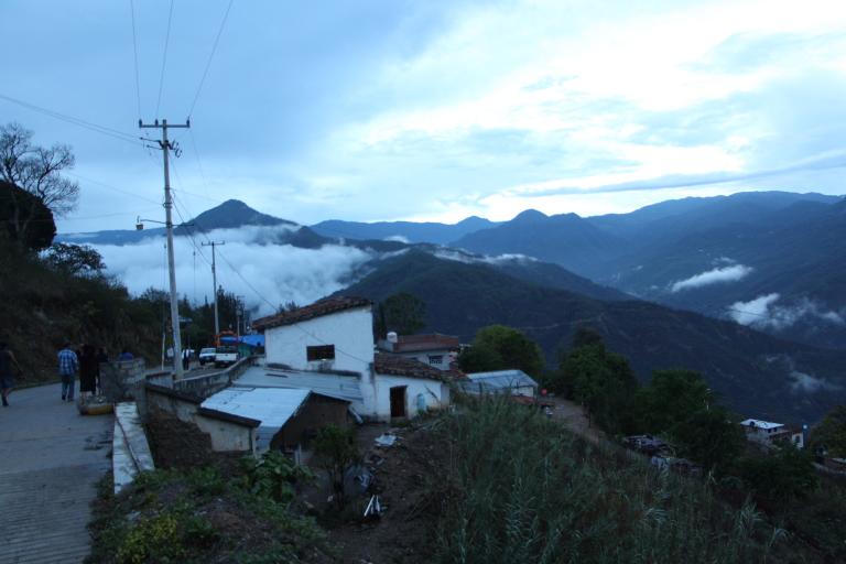 Early morning mist over a hillside village in Sierra Juárez