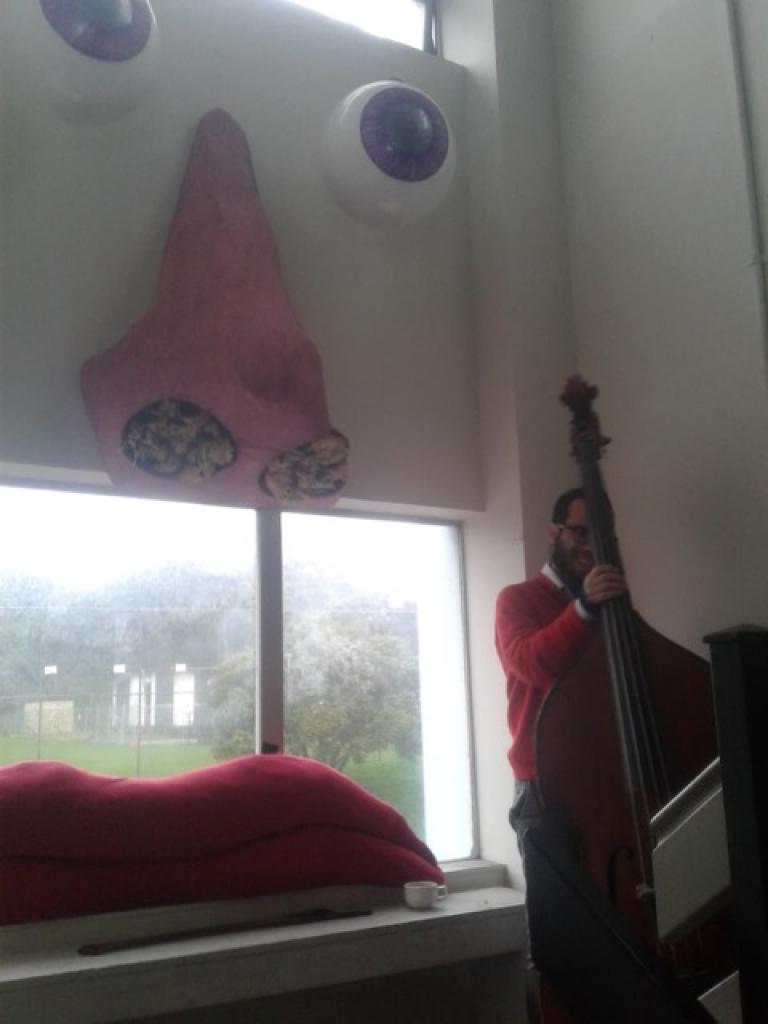 Isaac Smith taking pause, holding his double bass
