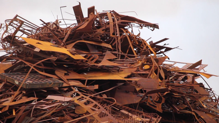 A large pile of rusted scrap metal sitting in a heap. It is spiky and uninviting.