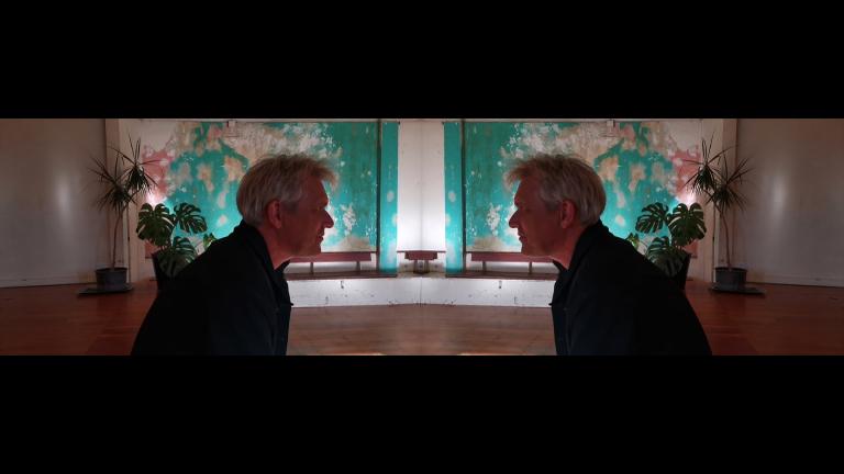 An image that is mirrored down the middle. Gabriel White appears to be staring intently at himself.